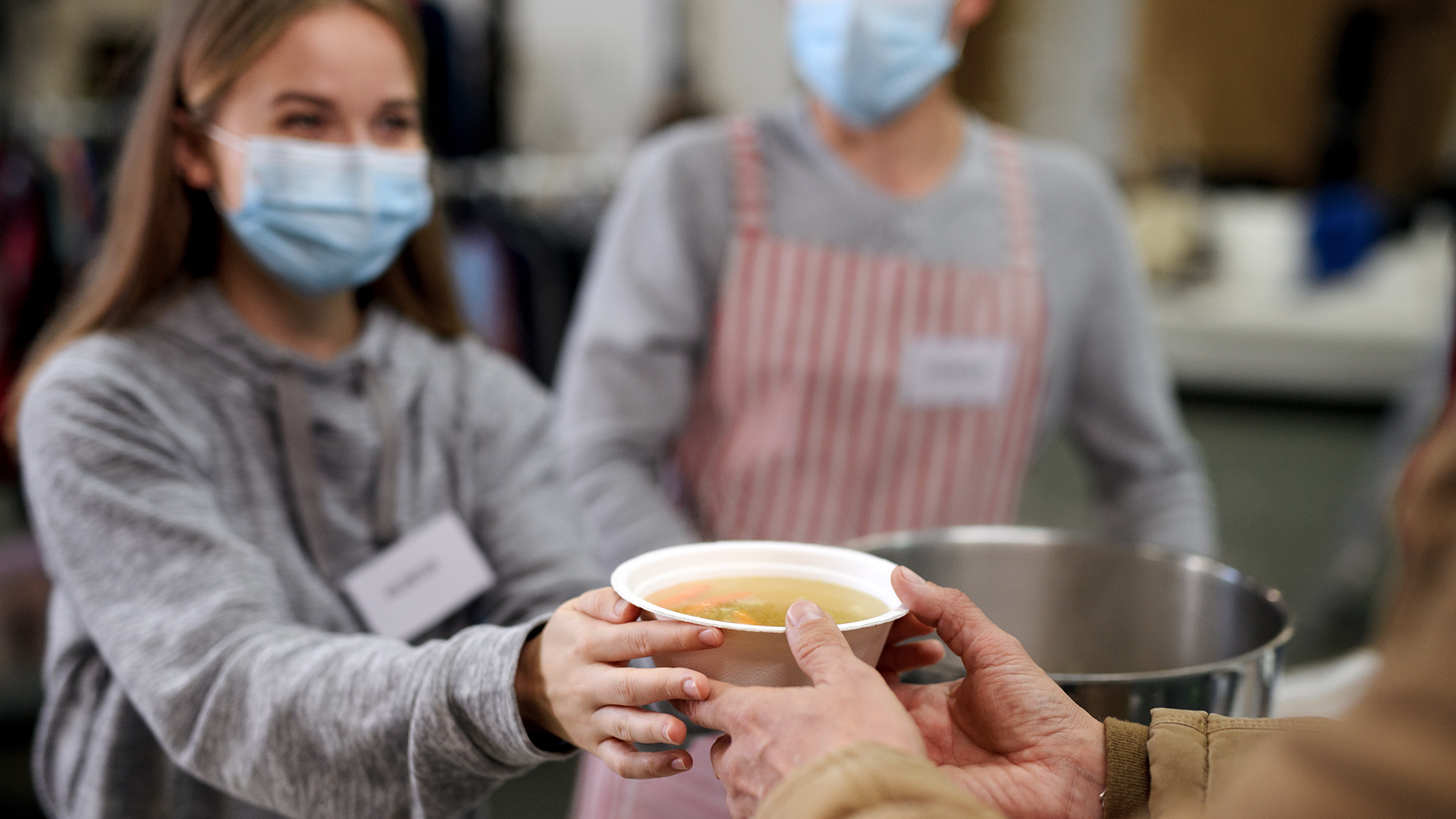 wonan serving soup at a soup kitchen