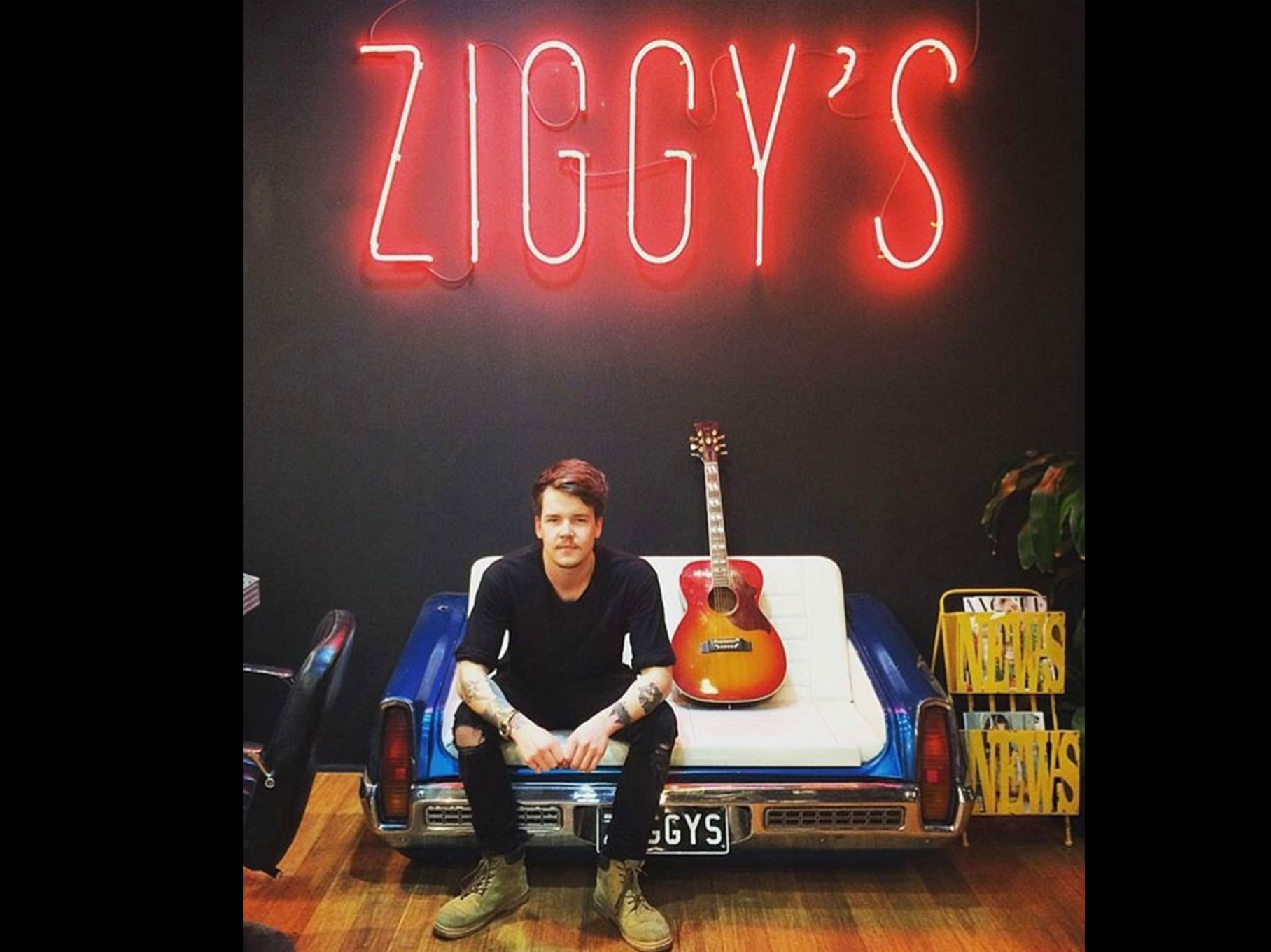 Andy from Ziggys in salon under Ziggys neon sign